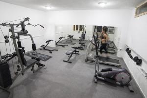 a woman in a gym with several tread machines at Elpida Village in Istro