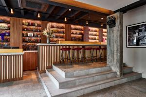 a bar with two stools in a restaurant at The Scott Hotel Brussels in Brussels