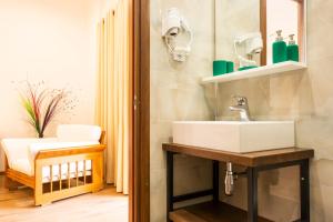 a bathroom with a sink and a mirror at sofia's cozy rooms in Himare +33 photos