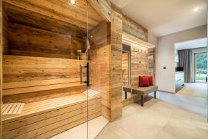 a sauna in a bathroom with wooden walls at Seebrunn - Kuppelwieser Alm in Ultimo +16 photos