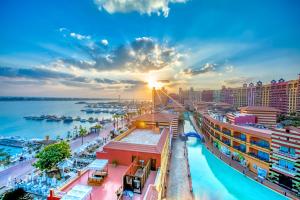 a cityscape of a harbor at sunset at Porto Marina Resort & Spa Al Alamein in El Alamein