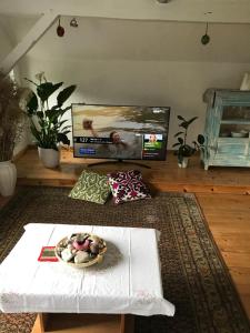 a living room with a table and a bowl of food at Hering FeWo II Apartment Balcony in Wiek auf Rügen
