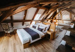 a bedroom with a large bed in a attic at Boutique hotel Corso in Řevnice