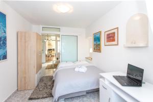 Postel nebo postele na pokoji v ubytování Apartments Tino