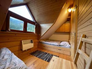 a small room with two beds in a cabin at Apartmány SKI Čertovica in Vyšná Boca
