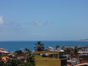 a view of the ocean from a city at Condomínio Mar Azul in Salvador