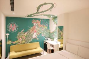 a bedroom with a wall with a dragon mural at CityInn Hotel Plus - Ximending Branch in Taipei