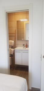 a white bathroom with a sink and a mirror at Lavan del Mar in Torre del Mar