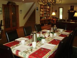 a dining room table with a red and white table cloth at La Petite Douceur in Lac-Superieur