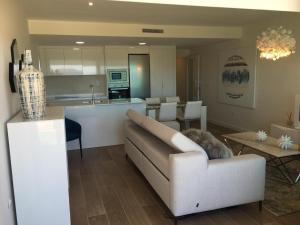 a living room with a couch and a kitchen at 'Dreamy sunsets' - appartement met 3 slaapkamers in Playa Honda