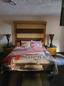 a bed that has a blanket on top of it at Route 66 Hotel, Springfield, Illinois in Springfield