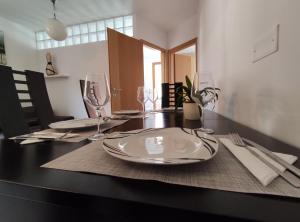 a dining room table with plates and glasses on it at Apartments Bohinjc in Bohinj