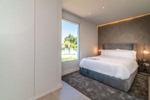 a bedroom with a large bed and a large window at Exclusive House located in Prime location in Marbella