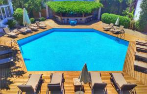an overhead view of a swimming pool with chairs and umbrellas at Costa Bodrum City in Bodrum City