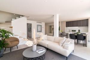 a living room with a couch and a table at Exclusive House located in Prime location in Marbella