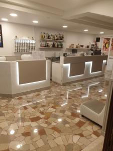 a room with a store with a counter and a floor at Hotel Grand Prix in Sottomarina