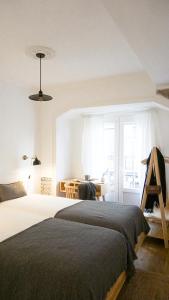 a bedroom with a large bed and a desk at 262 Baixa Guesthouse in Lisbon