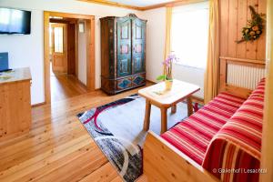 a living room with a couch and a table at Gailerhof in Liesing