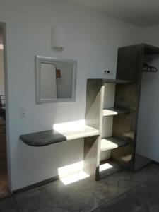 a shelf in a room with a mirror on the wall at Studio farma in Zefiría