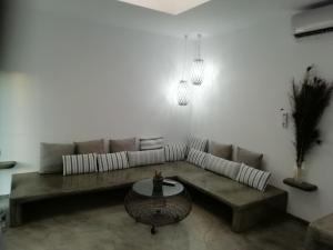 a living room with a couch and a table at Studio farma in Zefiría