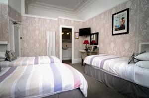 A bed or beds in a room at Kingsway Guest House