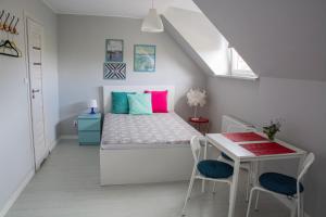 a bedroom with a bed and a table and chairs at Dom przy borowinie in Kołobrzeg
