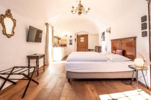 a bedroom with a large bed and a table at Stammhaus - Premium Residences in Rauris
