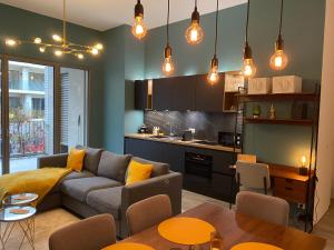 a living room with a couch and a kitchen at Bright and chic apartment in Lux City in Luxembourg +7 photos