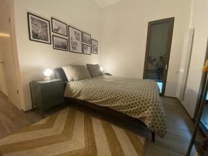 a bedroom with a bed and a nightstand and a window at Bright and chic apartment in Lux City in Luxembourg