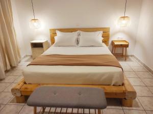 a bedroom with a large bed with a wooden headboard at Seamore Pension in Galaxidhion