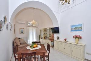 a kitchen and living room with a table and chairs at Casa del Fauno in Minori