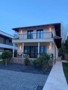 a large house with a balcony and a driveway at DV Premium Apartments in Siófok