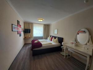 a hotel room with a bed and a mirror at Hotel Kirchenwirt in Bad Kleinkirchheim