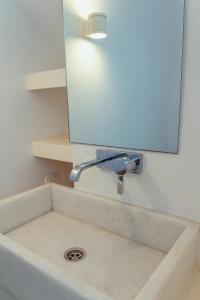 a bathroom sink with a mirror above it at Rooftop House in the old town of Parikia - Paros in Parikia