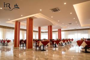 a banquet hall with tables and chairs in a building at Hotel Reali in Chianciano Terme