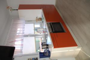 a staircase with an orange and white cabinet in a room at Ferienwohnung Prey in Ueckermünde