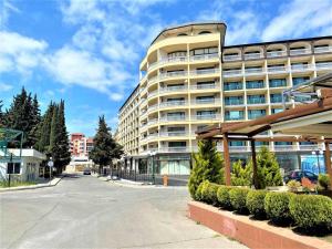 a large apartment building on a street with a parking lot at Menada Miramar Palace Apartments in Sunny Beach