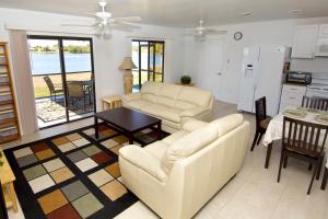 a living room with a couch and a table at Lilsis by the Lake in Port Charlotte