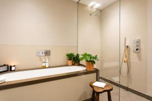 a bathroom with a shower and a toilet and a sink at 56 Welbeck Street in London