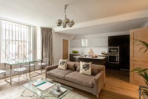 a living room with a couch and a table at 56 Welbeck Street in London