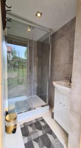 a bathroom with a shower and a sink at Chatka Gargamela in Mikołajki