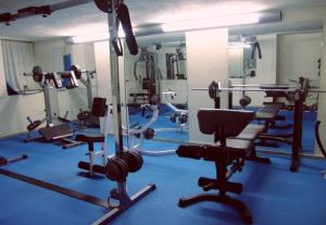 a gym with several rows of chairs and machines at Laodamia Hotel in Nea Anchialos