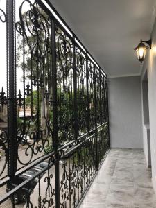 a black iron fence with a view of a street at Квартира 3-комнатная ЛЮКС in Sukhum