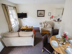 a living room with a couch and a table at Lord High Admiral in Winchcombe