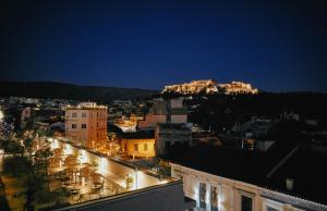 a large building with a clock on top of it at MiraMe Athens Boutique Hotel-House of Gastronomy in Athens
