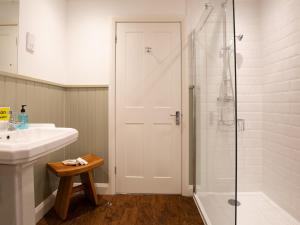 a white bathroom with a shower and a sink at Lord High Admiral in Winchcombe +12 photos