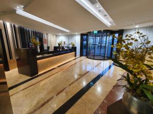 a lobby of a hotel with a reception desk at Nash Suites Airport Hotel in Geneva