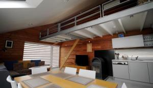 Sala de estar con mesa de comedor y loft en Namai pas Gintarą, en Palanga