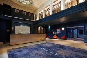 a lobby with a large screen in a building at The Dilly in London