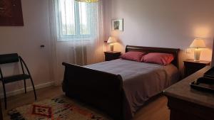 a bedroom with a bed and two lamps and a window at Bastia Appartement 3 chambres vue mer in Bastia